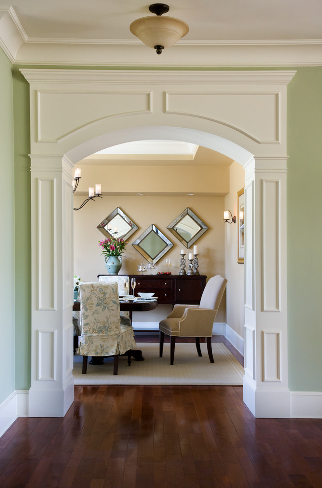 Inspiration for a large timeless medium tone wood floor and brown floor hallway remodel in Boston with green walls