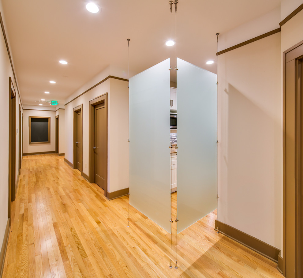 Large elegant light wood floor hallway photo in Seattle with white walls