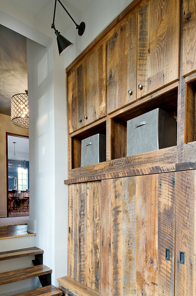 Example of a mid-sized transitional medium tone wood floor and brown floor hallway design in Other with white walls