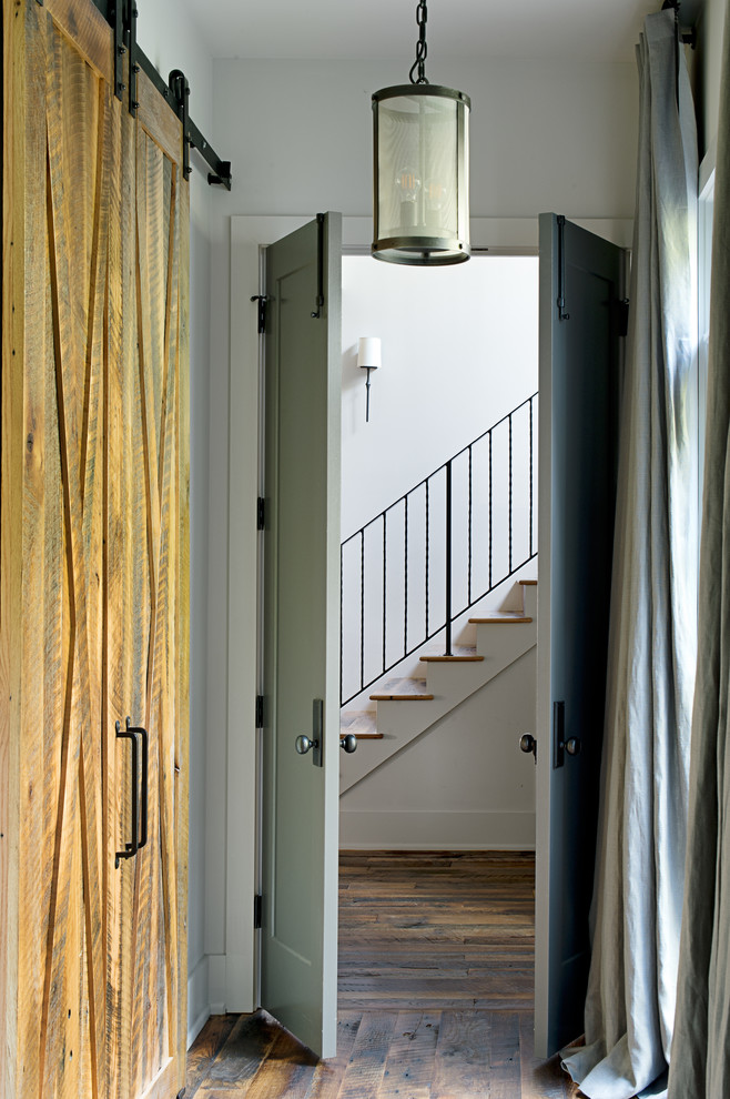Example of a mid-sized transitional medium tone wood floor and brown floor hallway design in Other with white walls