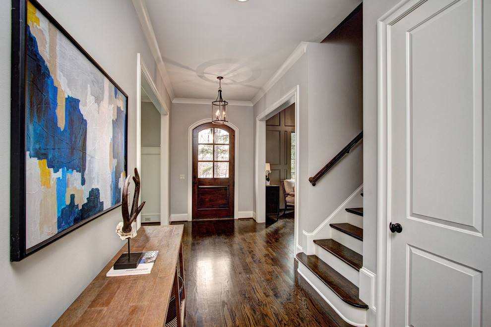Inspiration for a large transitional dark wood floor hallway remodel in Charlotte with gray walls
