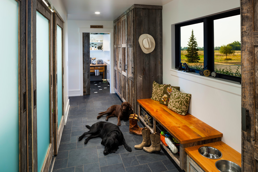 Example of a mountain style gray floor hallway design in Other with white walls
