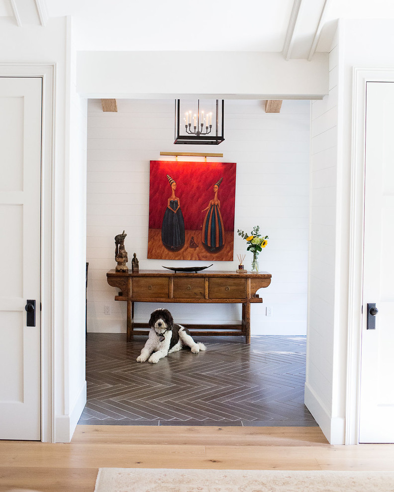 Example of a transitional gray floor hallway design in Los Angeles with white walls