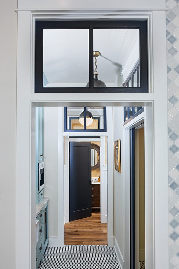 Inspiration for a mid-sized transitional porcelain tile and multicolored floor hallway remodel in Grand Rapids with white walls