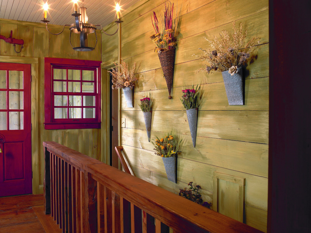 Inspiration for a large rustic dark wood floor hallway remodel in Other with green walls