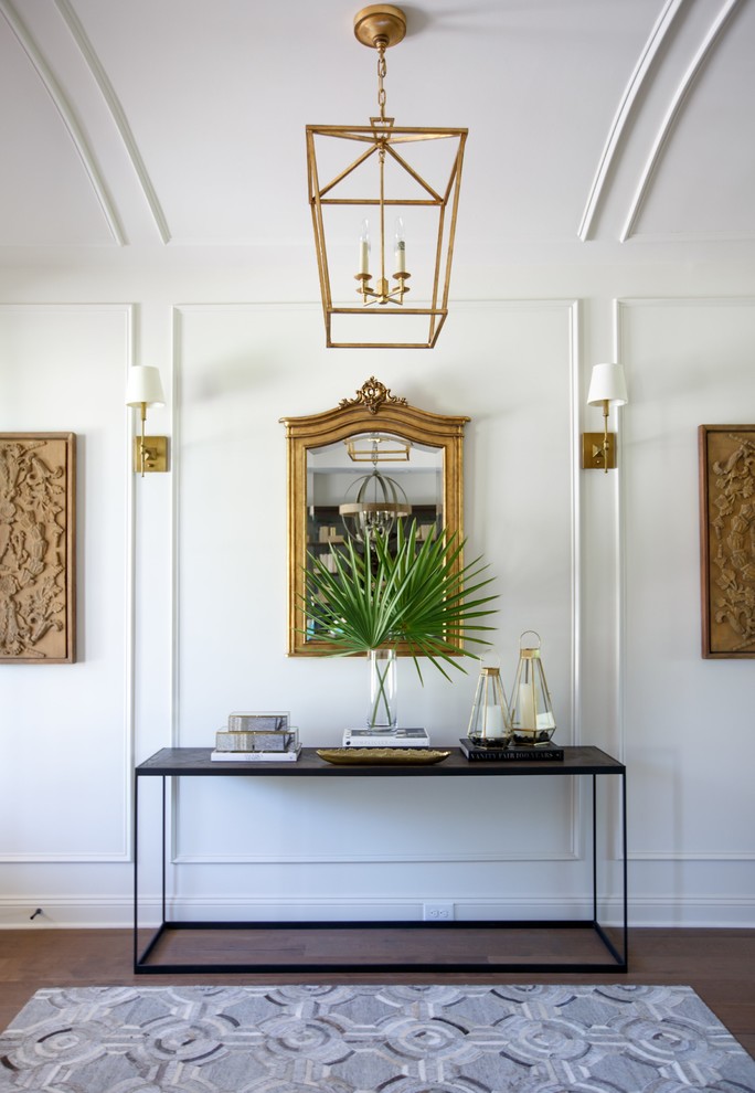 Transitional medium tone wood floor hallway photo in Jacksonville with white walls
