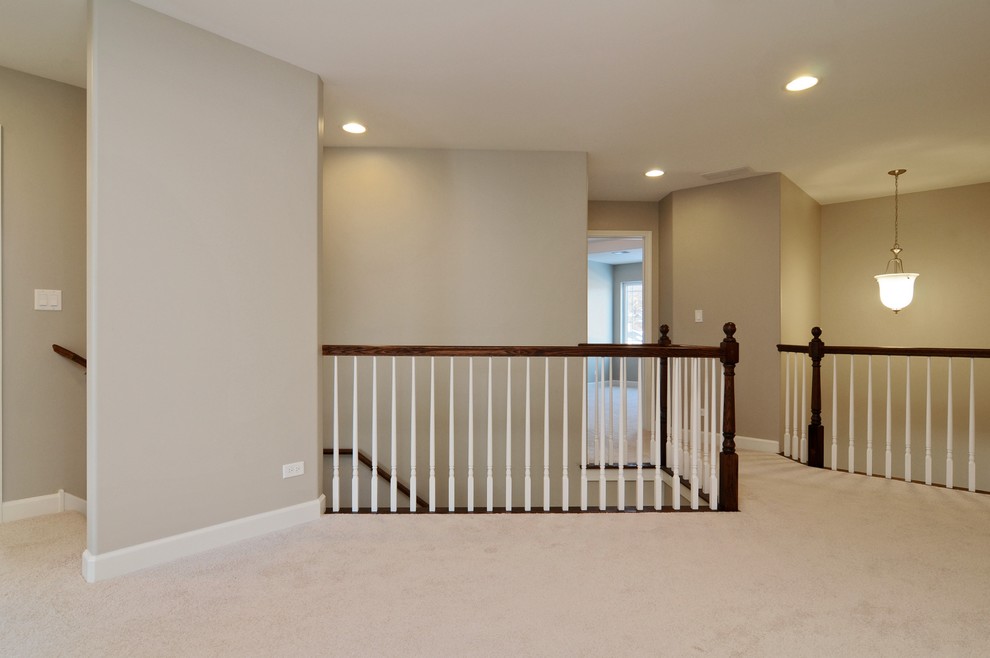Inspiration for a mid-sized transitional carpeted hallway remodel in Chicago with gray walls