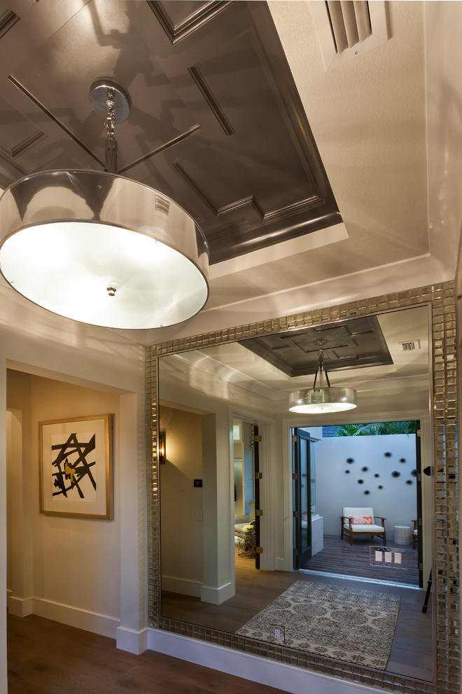 Hallway - large transitional medium tone wood floor and brown floor hallway idea in Tampa with beige walls