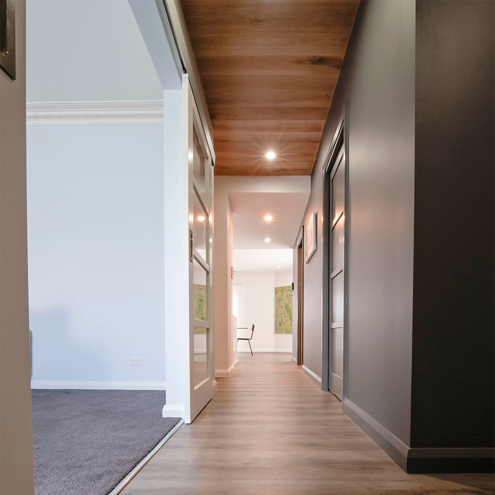 Inspiration pour un couloir design de taille moyenne avec un mur gris.