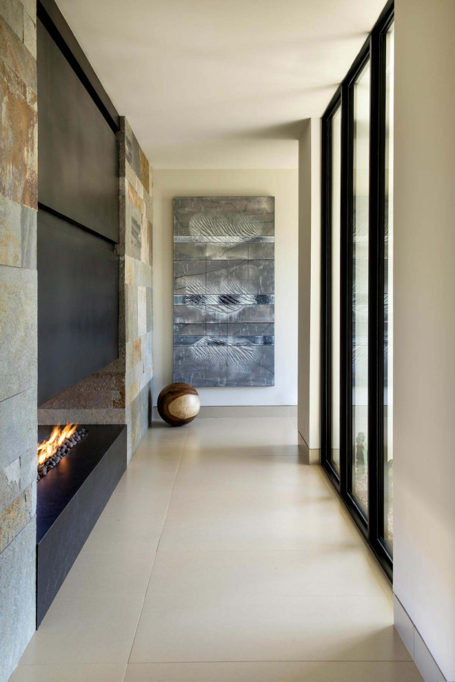 Inspiration for a huge contemporary beige floor hallway remodel in Phoenix with white walls