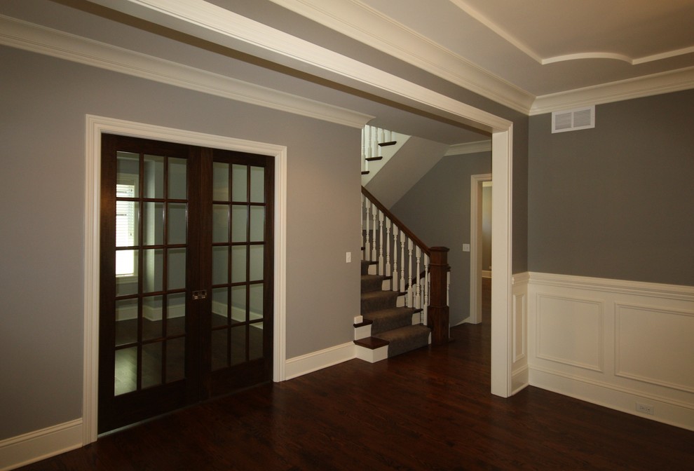 Hallway - large traditional dark wood floor and brown floor hallway idea in Chicago with gray walls