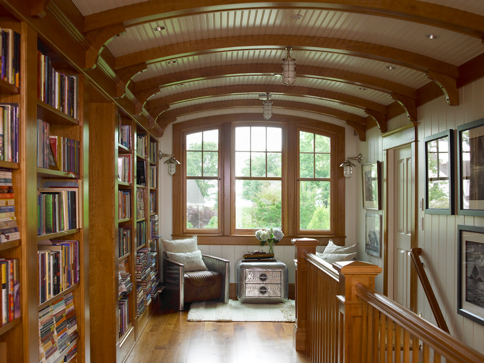 Example of a classic medium tone wood floor hallway design in Baltimore with white walls