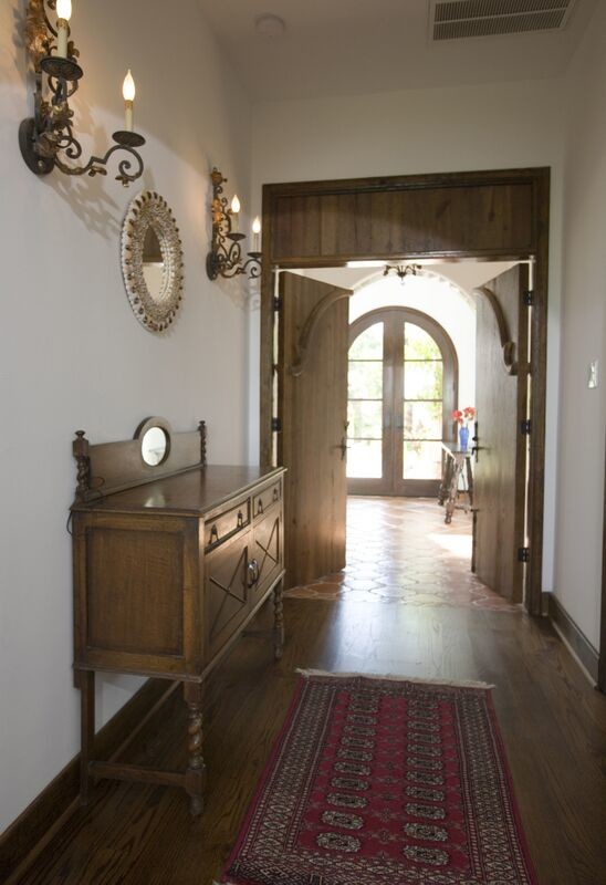Hallway - mid-sized traditional medium tone wood floor and brown floor hallway idea in Houston with beige walls