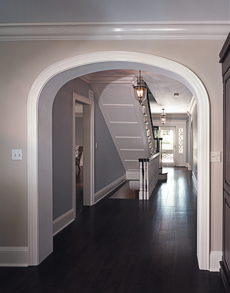 Hallway - large transitional dark wood floor and black floor hallway idea in New York with beige walls