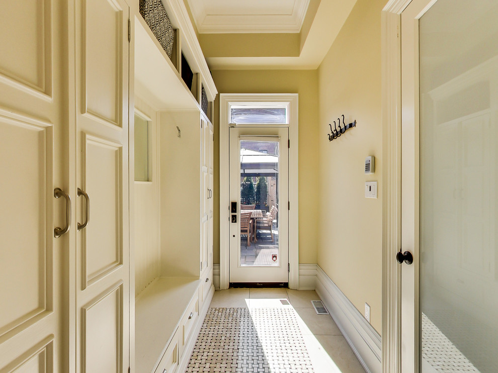 Hallway - transitional marble floor hallway idea in Toronto with yellow walls