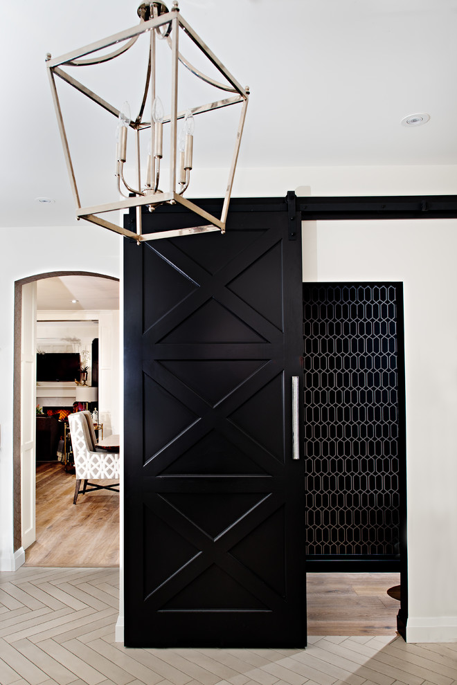 Mid-sized transitional medium tone wood floor hallway photo in Toronto with black walls