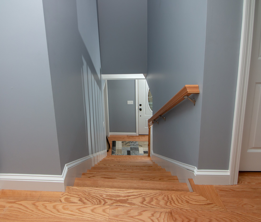 Hallway - mid-sized transitional medium tone wood floor and orange floor hallway idea in Boston with gray walls