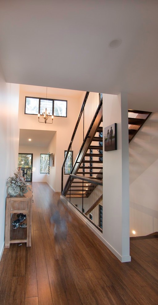 Inspiration for a contemporary bamboo floor hallway remodel in Other with white walls