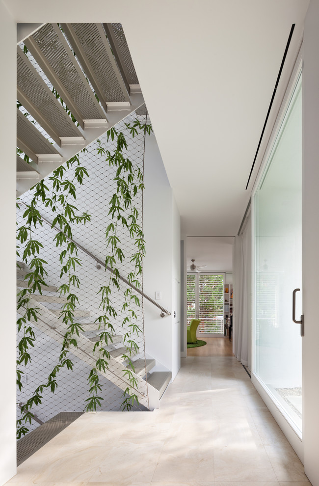 Example of a trendy white floor hallway design in DC Metro with white walls
