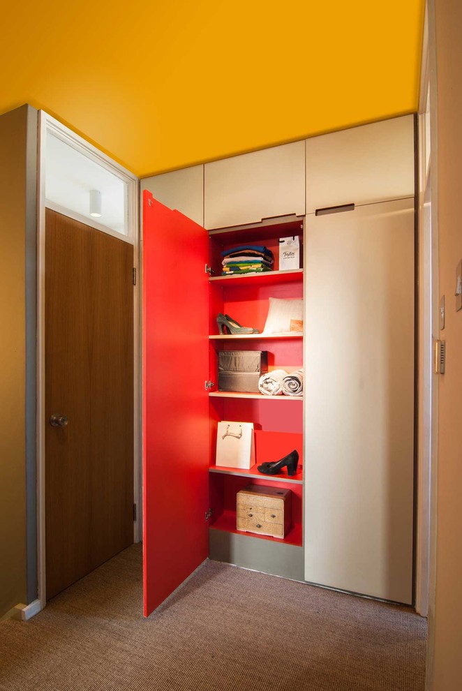 Esempio di un piccolo ingresso o corridoio minimal con pareti gialle e moquette