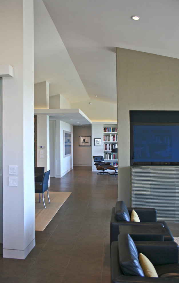 Example of a mid-sized minimalist porcelain tile hallway design in Orange County with white walls