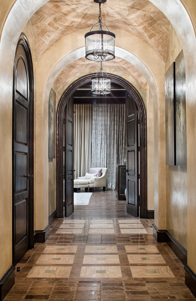 Example of a tuscan hallway design in Houston with beige walls
