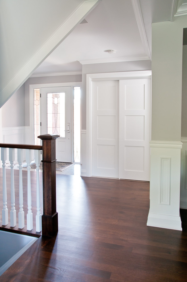 Hallway - mid-sized transitional dark wood floor and brown floor hallway idea in Toronto with gray walls