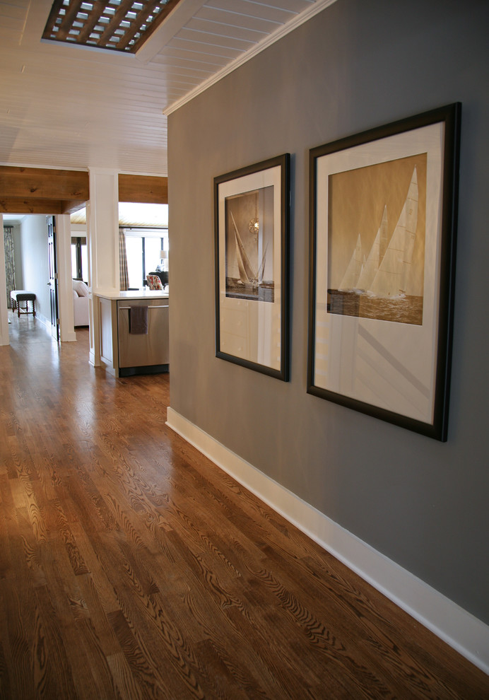 Mid-sized eclectic medium tone wood floor hallway photo in Milwaukee with gray walls
