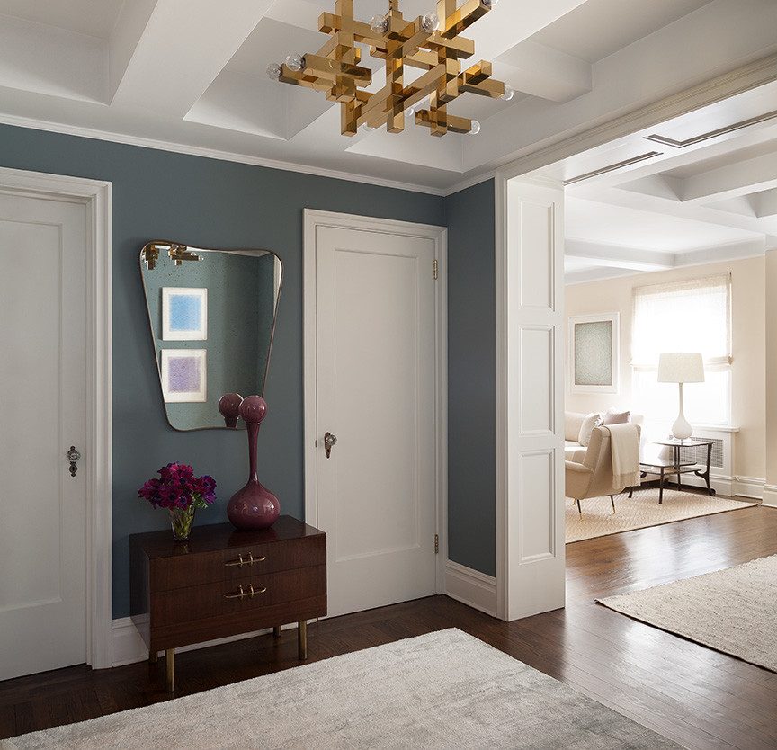 Example of a trendy dark wood floor hallway design in New York with blue walls