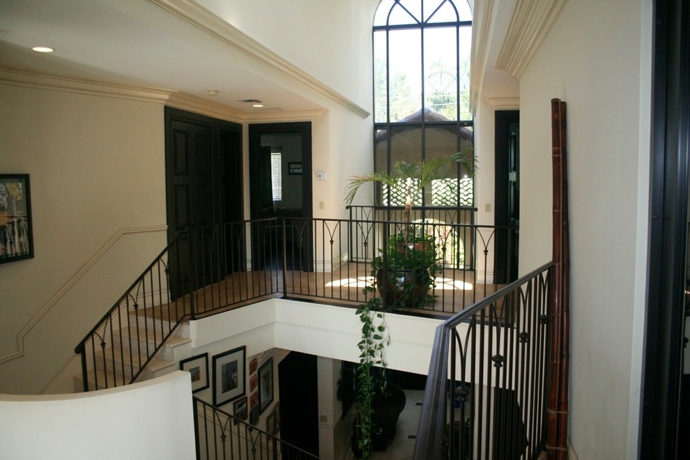 Hallway - mid-sized traditional medium tone wood floor and beige floor hallway idea in Miami with white walls