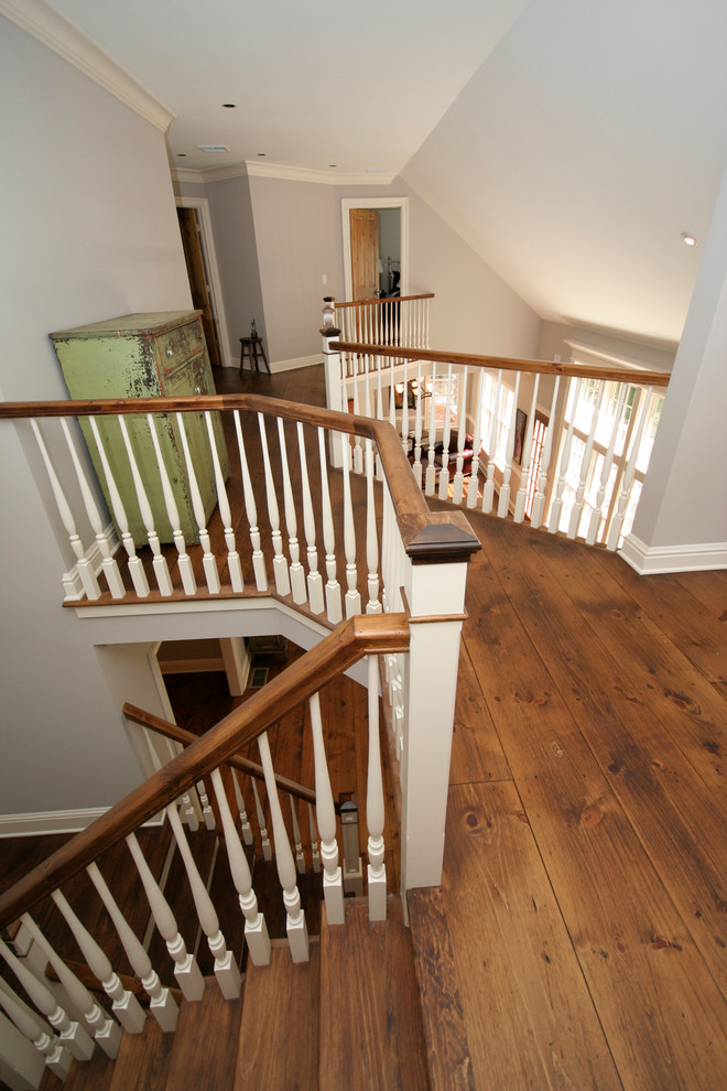 Example of a cottage medium tone wood floor hallway design in New York with gray walls