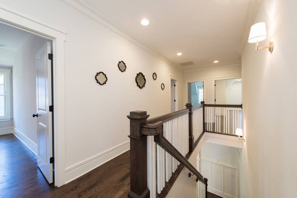Inspiration for a mid-sized timeless medium tone wood floor and brown floor hallway remodel in Charlotte with white walls