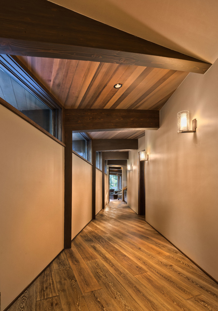 Hallway - large rustic medium tone wood floor hallway idea in Sacramento with beige walls