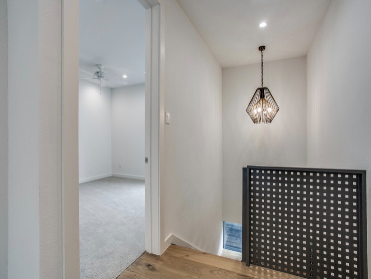 Esempio di un ingresso o corridoio minimalista con pareti bianche, pavimento in laminato e pavimento marrone