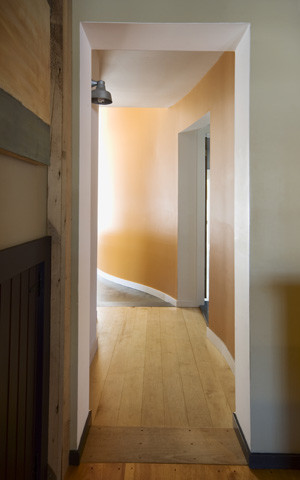 Mid-sized cottage light wood floor hallway photo in Burlington with brown walls