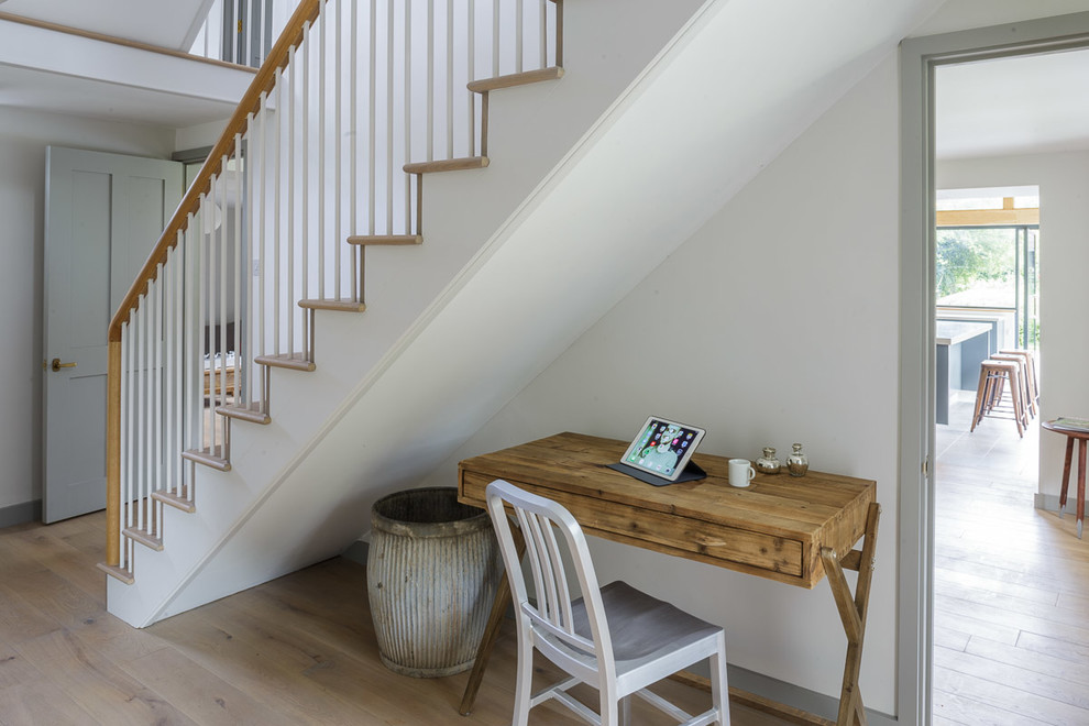 Example of a mid-sized transitional light wood floor hallway design in Wiltshire with white walls