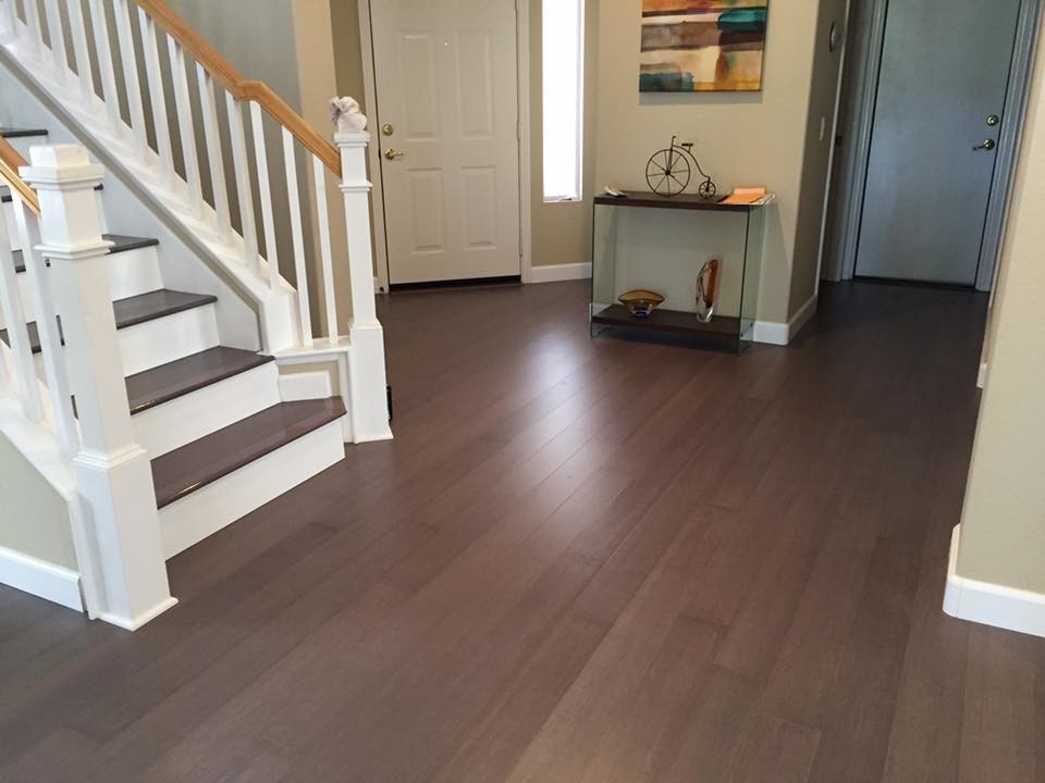 Example of a trendy bamboo floor and gray floor hallway design in San Diego with multicolored walls