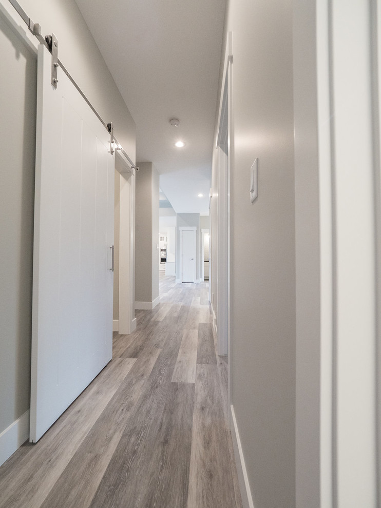 Example of a mid-sized mountain style vinyl floor and multicolored floor hallway design in Edmonton with gray walls