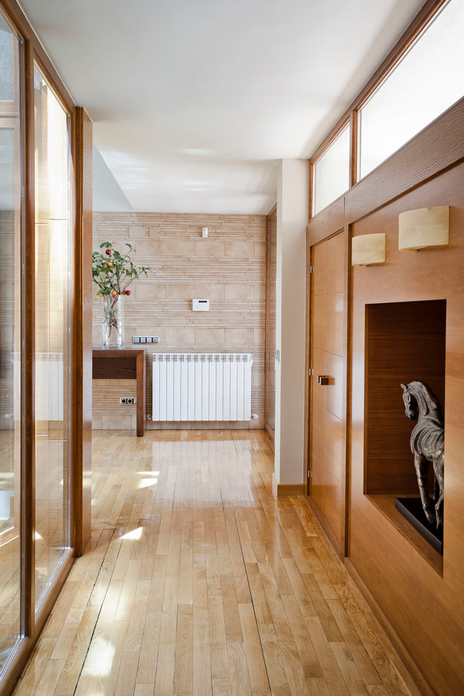 Стильный дизайн: коридор среднего размера в стиле неоклассика (современная классика) с коричневыми стенами и светлым паркетным полом - последний тренд