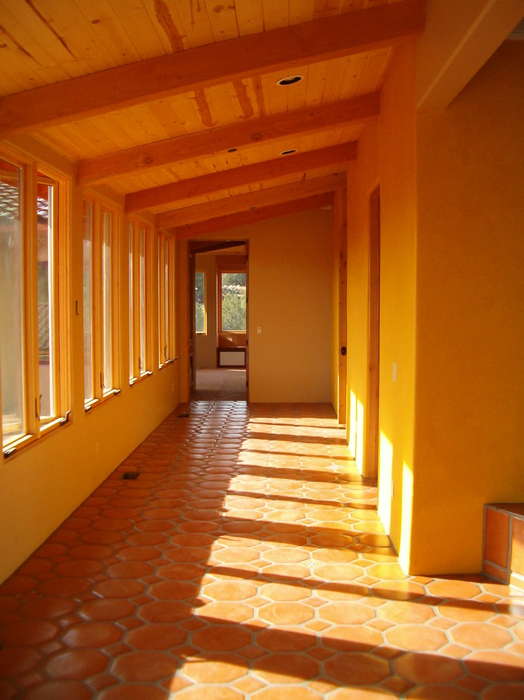 Ejemplo de recibidores y pasillos de estilo americano de tamaño medio con suelo de baldosas de terracota