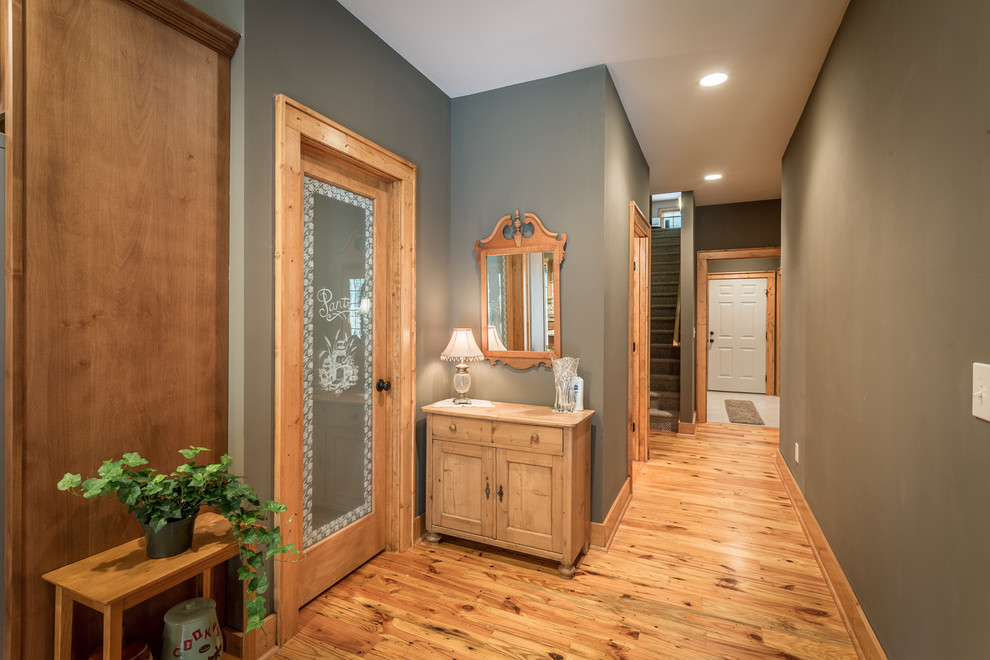 Mid-sized mountain style medium tone wood floor hallway photo in Charlotte with gray walls