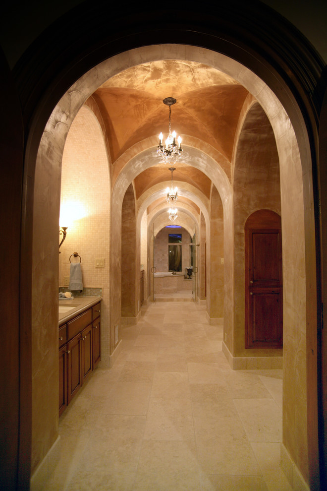 Inspiration for a large mediterranean limestone floor hallway remodel in Austin with beige walls