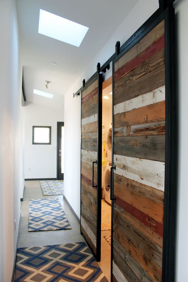 Inspiration for a small contemporary concrete floor hallway remodel in Denver with white walls