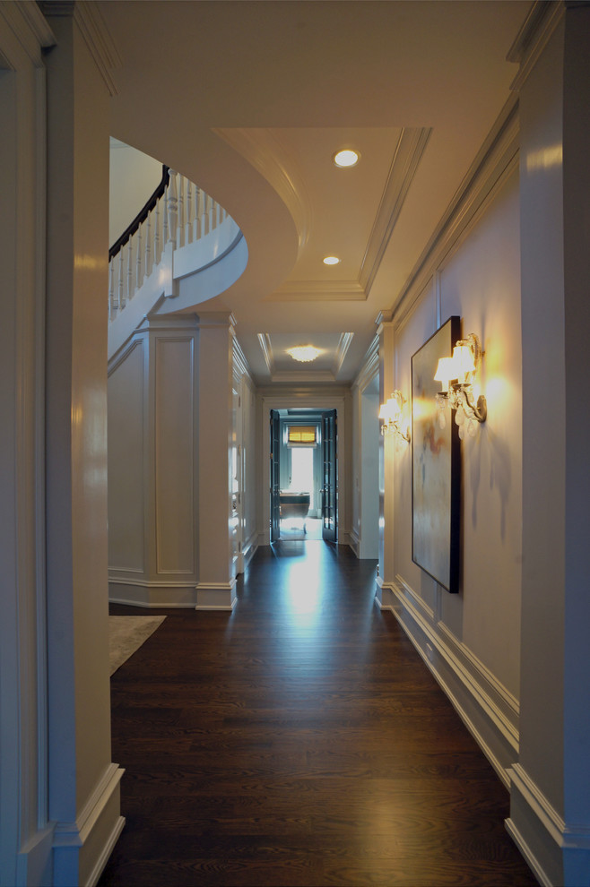 Large elegant dark wood floor hallway photo in Chicago with white walls
