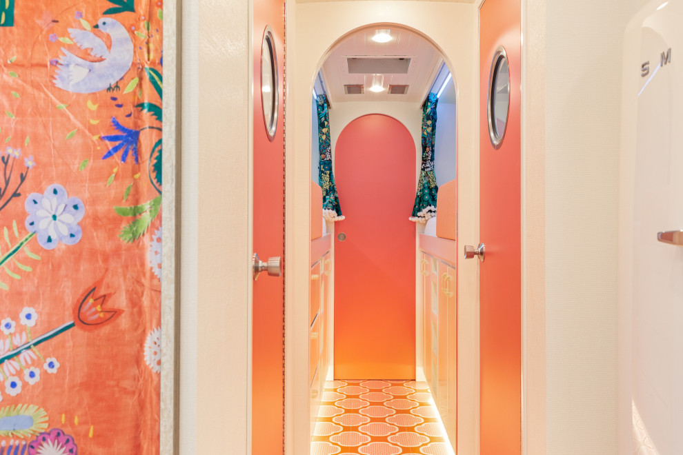 Hallway - small eclectic painted wood floor and orange floor hallway idea in Los Angeles with white walls