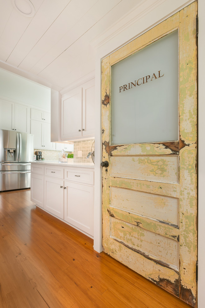 Hallway - mid-sized craftsman medium tone wood floor hallway idea in Charleston with white walls
