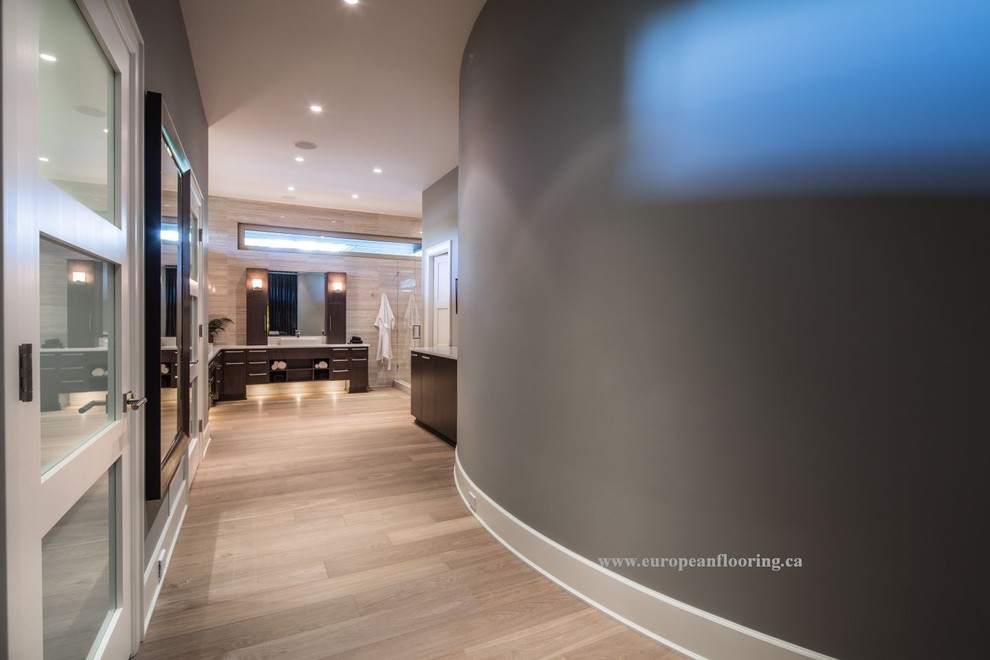 Hallway - mid-sized contemporary medium tone wood floor hallway idea in Toronto with gray walls