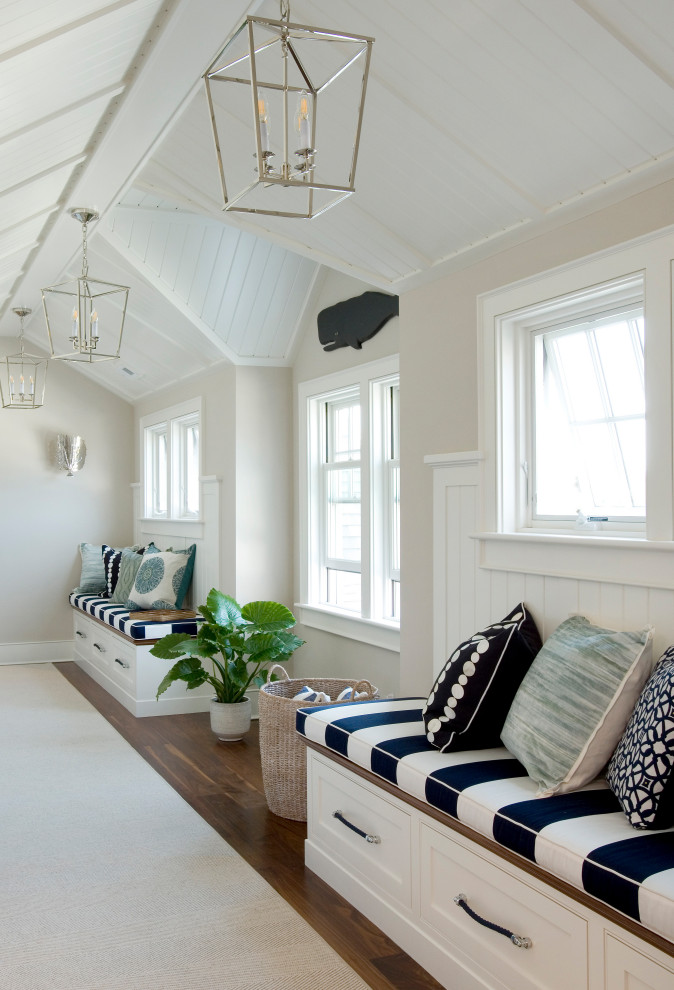Inspiration for a coastal dark wood floor, brown floor and vaulted ceiling hallway remodel in Boston with beige walls
