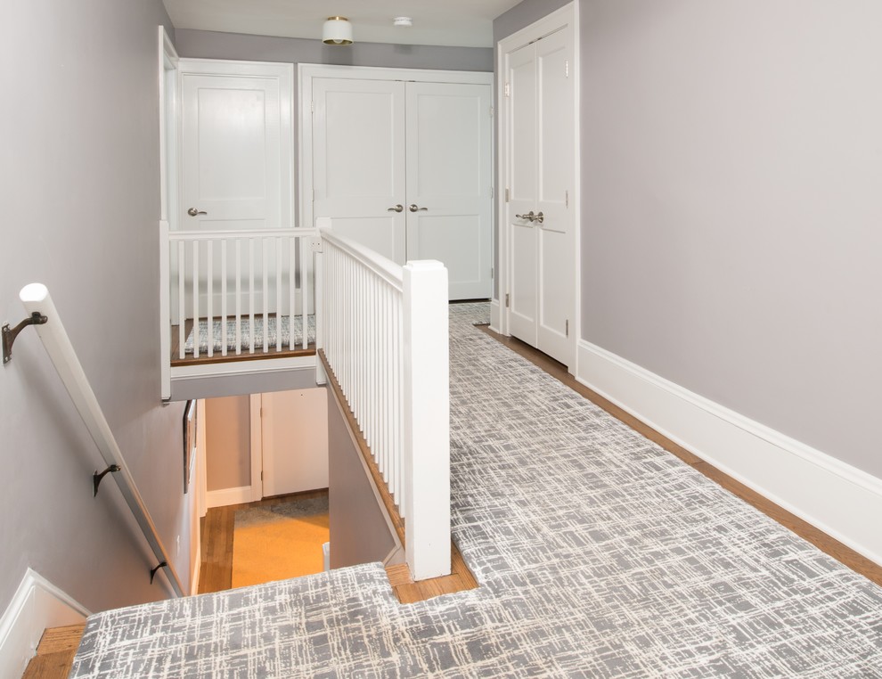 Hallway - mid-sized transitional medium tone wood floor and brown floor hallway idea in Boston with gray walls