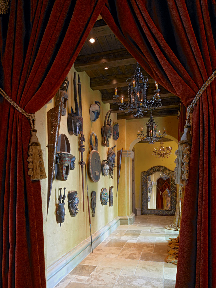 Hallway - large mediterranean travertine floor hallway idea in Orlando with beige walls